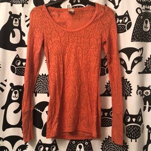 Orange long sleeve shirt.